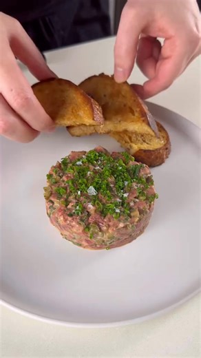 Steak Tartare Recipe: I got a beef fillet mignon that I placed 10mins in the freezer to firm up. In the bowl, I had chopped shallots, chopped parsley, chives, chopped cornichons, chopped capers, a tbsp of dijon mustard, egg yolk, tabasco, Worcestershire sauce, salt and pepper. Served with toasted sourdough bread. #food #fyp #Foodie #foodtiktok #cooking #beef #steak #steaktiktok #tartare | jad saad