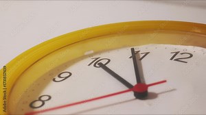 Timelapse of a clock face showing hours and minutes moving quickly