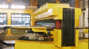 view on press cutting machine on a car factory, robotic production of detail for cars