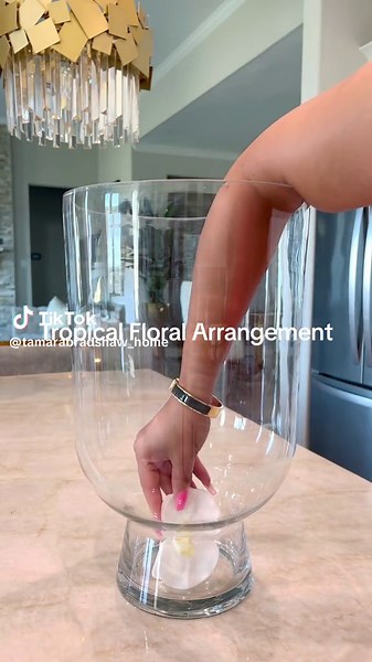 DIY Tropical Floral Arrangement🌴 Do we love? And what do rate this btwn 1 and 10?!✨ I will be doing a tropical theme setting for a get together. And this will be my beautiful centerpiece!! Stay tuned for the tablescape✨ CLICK LINK IN MY BIO to shop all the palm leaves I put in outer vase and orchid stems. The other stems are from Hobby Lobby. And I got vases from Home Goods. This is so easy to make!!!✨ #diy #flowers #flowerareangement #flowerarrangements #orchids #tropical