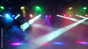 Multi-colored stage lights, light show at the concert. Light and smoke show on the stage.