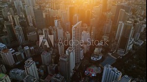 Aerial view of skyscrapers buildings in Makati business district and Manila city at sunset, capital of Philippines, 4k