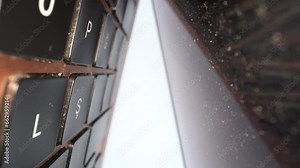 Dusty laptop keyboard keys close up 4K