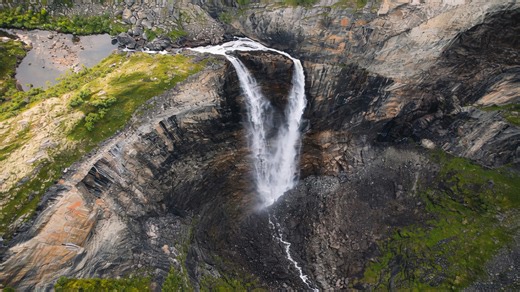 A massive waterfall falling straight into a mountain gorge