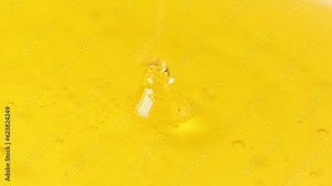Thick liquid of honey dripping on honey. Closeup healthy organic. Thick honey dipping. Healthy food concept. Drops of golden honey flowing down.