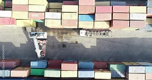 Container Handler Loading a Truck in Port Terminal. Transportation of the containers for export and import the goods to the cargo