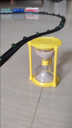 Marbles are on the track near the hour glass and the train is approaching fast | Marble Videos