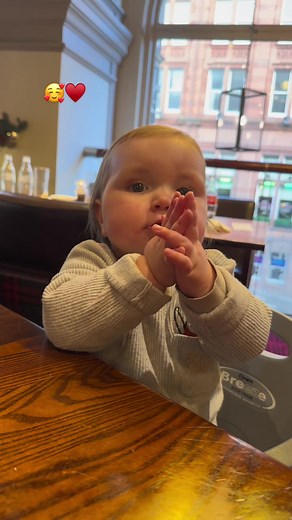 Adorable Child Clapping at Café