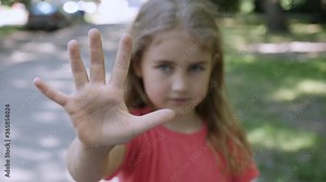 Stop Sign Hand Child Person Portrait. Little Girl Annoyed Making Stop Sign With Hand, Saying No, Expressing Defense or Restriction. Social Distance. Virus, violence, abortion, corruption, inequality.