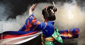 4K beautiful Japanese geisha dancing on stage and posing for the camera,the smoke in the background, slow motion