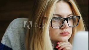 closeup portrait of female person using portable computer laptop looking monitor sad worried emotional face checking news hipster glasses blond woman internet business project manager browser connect