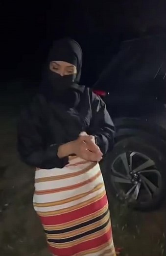 Nighttime Outdoor Dance Performance in Striped Skirt