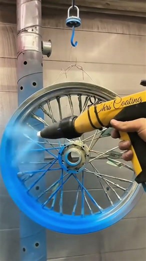 powder coating a metal motorcycle wheel rim with blue pigment