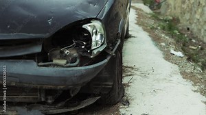 Damaged Vehicle Resting on Roadside Showcases Aftermath of Severe Collision, Emphasizing Impact of Traffic Accidents and Importance of Road Safety Awareness