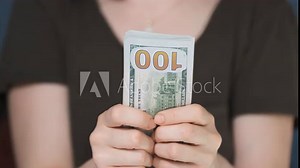 Pushing Dollar Banknotes Towards to Camera. Unrecognizable Person Counting and Giving Money. Making a Payment or Playing on Gamble Table. High Angle Shot of Bills. Indoor 4K Shot.