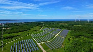 Industrial Solar panel green energy sun next to wind turbine farm eco friendly