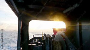 Back side view of furry boat with flight of seagull flying over calm ocean sea wave n Bright sun light ray or lens flare bokeh shining through ship anchor on pastel sky, 4k cinemagraphs b-roll footage