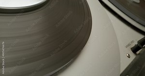 Sound recording on a tape recorder in a recording studio. Fast movement of the magnetic tape, close-up