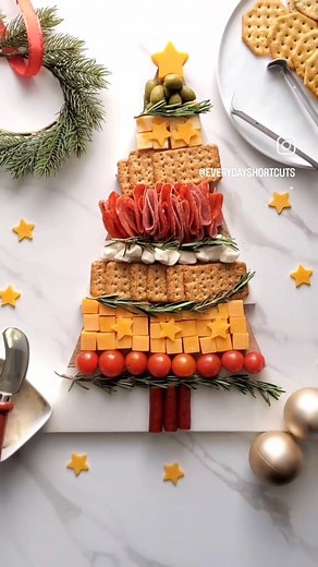 This Christmas tree charcuterie board is easy to make using your favorite meats, cheeses, crackers and veggies. Arrange in a tree shaped pattern with springs of rosemary in between, add a star cheese on top and throughout and enjoy! #charcuterieboardsofinstagram #charcuterieinspo #charcuterieboard #charcuterieboards #cheeseplate #christmastree #charcuterieplatter #holidayappetizers | Everyday Shortcuts by Alison McFadden