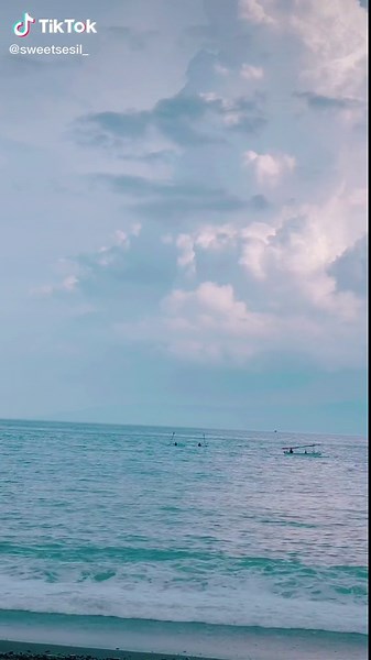 Serene Beach Walk with Waves and Boat Views