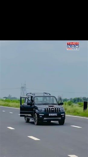 A man was caught on video with a Scorpio SUV’s passenger-side doors open, performing a dangerous stunt by climbing onto the moving vehicle’s bonnet and roof. The viral video, filmed alongside the SUV, led police to seize the car, arrest the driver, and issue a Rs 30,000 fine under the Motor Vehicles Act. Legal action is ongoing against the offender. [Scorpio stunt, viral reel, traffic police fine] #NewsWithTN | TIMES NOW
