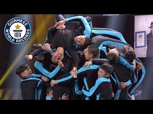 How Many People Can Front Flip Onto A Small Platform? - Guinness World Records