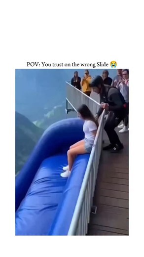 𝙀𝙓𝙋𝙇 🎬 on Instagram: "The post features an AI-generated video from Invideo depicting a woman sliding down a massive inflatable slide over a misty mountain cliff without harnesses, capturing a thrilling 18-meter freefall bounce that evokes intense adrenaline. Japanese text humorously ponders the rider's emotions during the unsafe descent, resonating with viewers for its mix of awe and terror, amassing nearly 3 million views and 449 replies within hours. @bitzcasino"