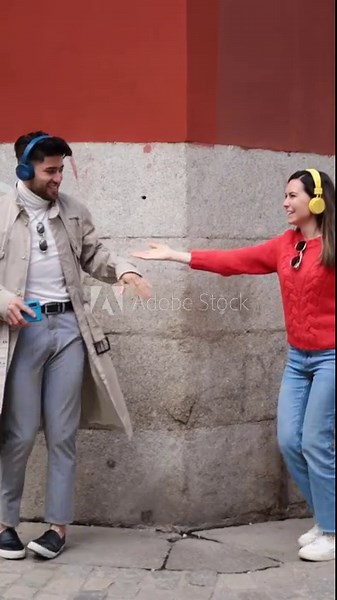Two friends dancing and having fun together. Vertical clip, slow-motion.