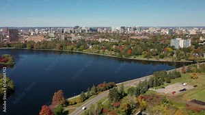 Drone video of downtown Ottawa, Canada's capital city with skyline in autumn changing leaves and Gatineau Park visible in background