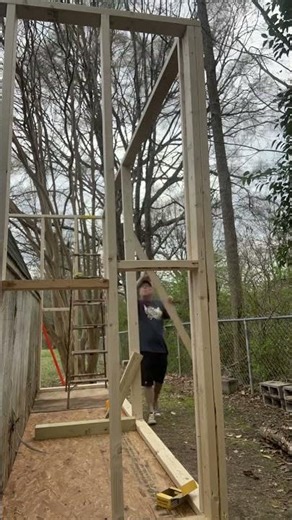 Working to install the back wall of our shop building.