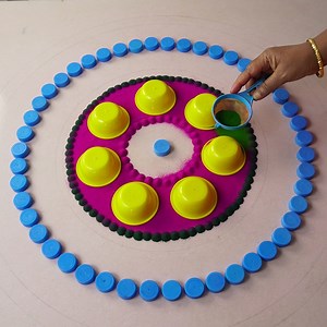 438K views · 416 shares | Simple and Easy Rangoli Designs Using Bottle Cap and Cups I used Bottle Cap and Cups to Design this Rangoli, Given Details using easily avilable things like Paint Brush, Glue Bottle and Colour powder. #rangoli #Simplerangoli #rangolibyjayanthig #satisfyingvideo #satisfying #relaxingvideo #relaxing #Hobbyideas #Easyrangoli #jayanthig | Simple Rangoli | Facebook