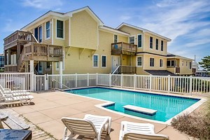 Two properties in one on the oceanfront, with an elevator. Relax and enjoy the custom concrete pool with a swim-up bar. The perfect setup for families who vacation together, but still want their own quality time. View more: https://www.outerbanksblue.com/vacation-rentals/now-and-then/NH027?nck=obbfacebook | Outer Banks Blue Vacation Rentals