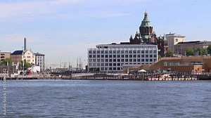 View of Helsinki Market Square from the harbor. The harbor area is popular for tourist sightseeing. The Helsinki Skywheel, the domed Uspenski Cathedral and buildings of architectural splendor ca