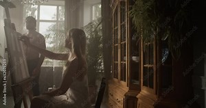 Talented female artist creating artwork in studio with male model