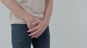 Download Man hold hand in front of private parts feeling discomfort from disease and inflammation. Venereal, testicular cancer. bladder problems, erectile dysfunction, premature ejaculation, prostate cancer for free