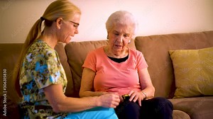 Measurement of the pulse on elderly woman. Placed on the finger heart rate monitor.