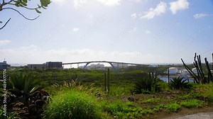 Queen Juliana Bridge over Saint Anna Bay in the city of Willemstad on the Caribbean island of Curacao. Slow motion push in