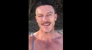 Luke Evans Is Shirtless on the Beach for His Christmas Video!