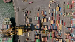 Birds eye shot of logistic site in harbour. Fly over international container terminal with stocks of naval containers. Colombo, Sri Lanka