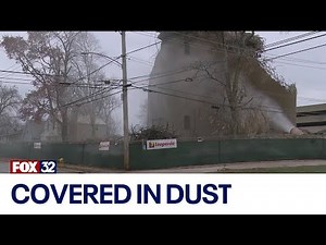 Water tower demolition leaves suburban homes covered in dust