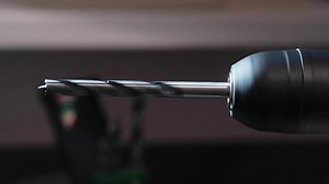 Rotating drill. Electric drilling machine with fixed drill bit for wood.