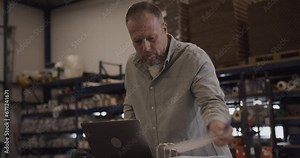 Logistic Shipping Manager Looking at Inventory in Folder