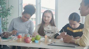 Group of student sitting and studying and learning drawing with teacher together in classroom at the school, pupils creativity and development for drawing in course, back to school, education concept.