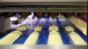 Automatic bakery line, close up of producing cakes in bakery industry