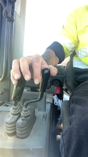 Operator hand view, cat 938 Front Loader. Cutting top soil on uneven ground
