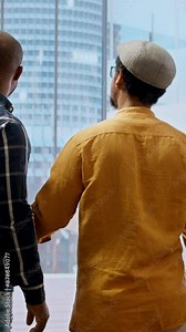 Vertical Video Real estate agent showcasing modern office blueprints to clients, discussing the architectural design and their vision to change the space for relocation. High class urban rental