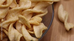 Delicious potato spring chips rotation close up video. Pea cracker crisp. Potato crackers chips seasoned with spices 4k footage.