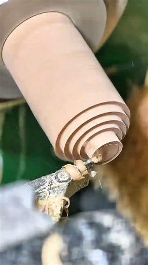 Lathe spins wood cylinder—hidden woodworking craft revealed in flawless symmetrical shaping