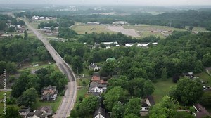 Aerial footage of the houses and green fields in Corydon town on a cloudy day in Indiana, USA