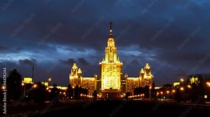 Moscow, Russia. Time-lapse of illuminated Lomonosov Moscow State University at night. Popular landmark in Russia. Time-lapse with car trails and dark fast pacing sunset sky. Pan